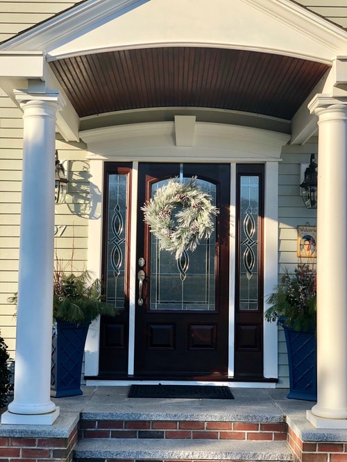 Front entry with white columns and dark door