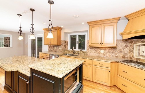 Kitchen with pendant lights and stone backsplash