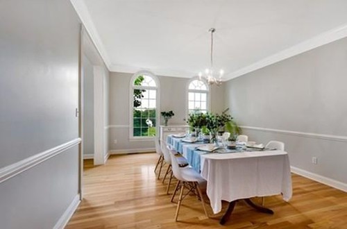 Formal dining room with gray walls and wainscoting