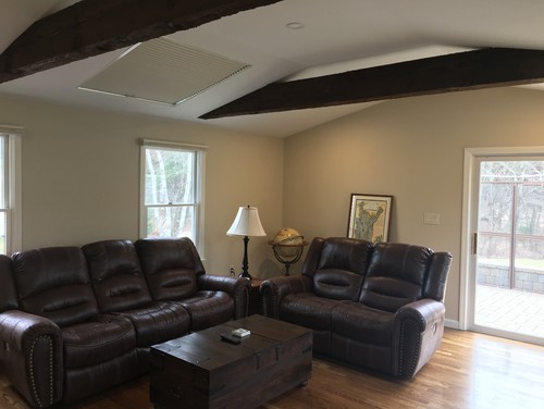 Living room with exposed beams and beige walls
