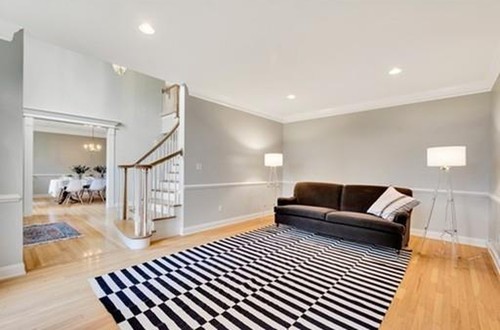 Living room with gray walls and wainscoting