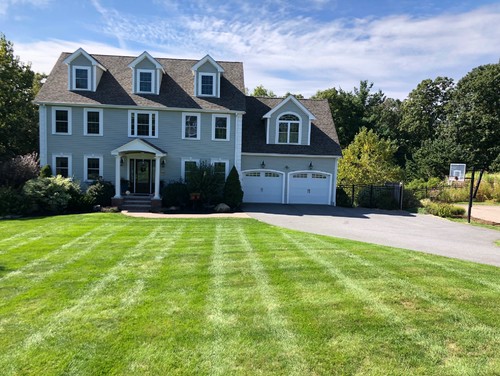 Colonial with blue-gray siding and dormers