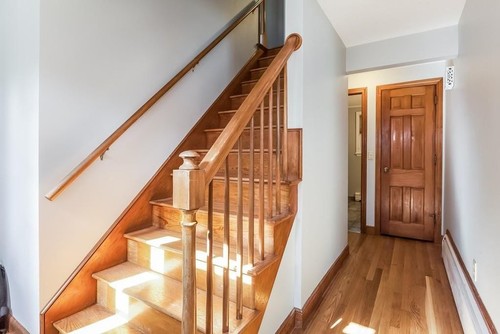 Traditional staircase with natural wood railing